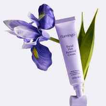 Tube of Flamingo Facial Hair Removal Cream pictured with a purple iris flower