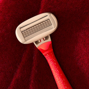Cranberry Fizz Original Razor Handle on a red fuzzy background.