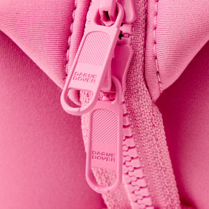Close up of the Dagne Dover toiletry bag's  pink zipper pulls.