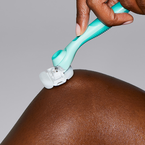 Person using the Seafoam Moisture Plus Razor to shave their knee.