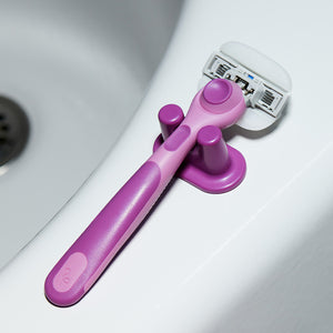 Fig Moisture Plus Razor with the shower holder on the edge of the bathtub.