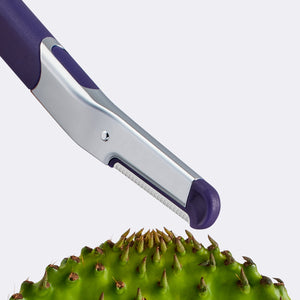 Flamingo Refillable Dermaplane Razor angled towards a green prickly pear cactus leaf
