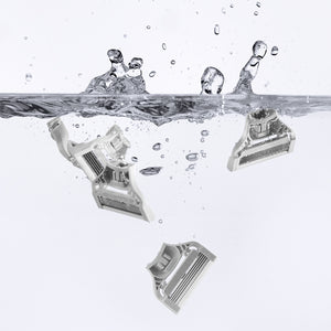 4 Pubic Blades floating in water with water splashing back on the surface.