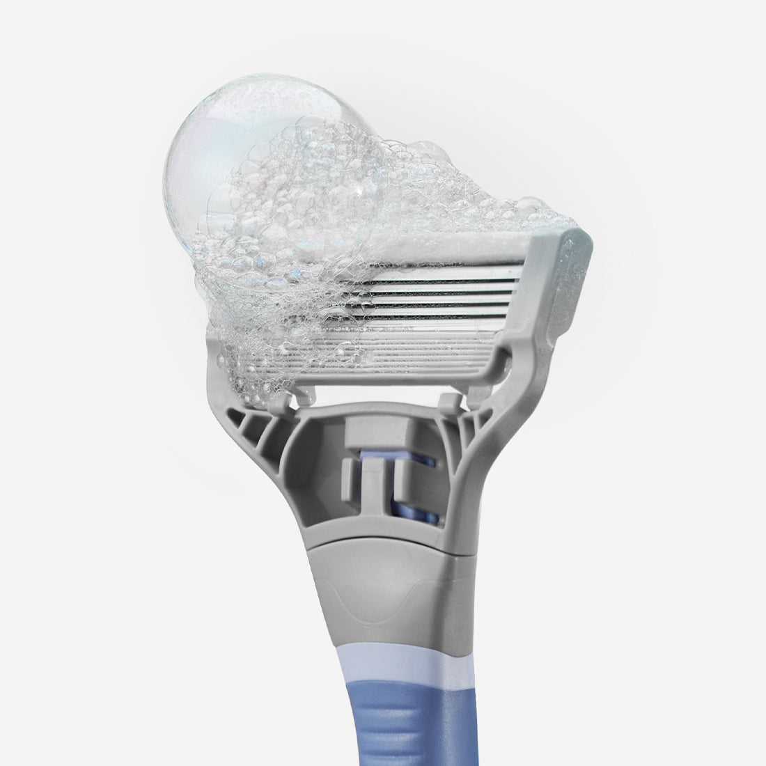 Close up of the Pubic Blade with foamy soap bubbles on the blade.