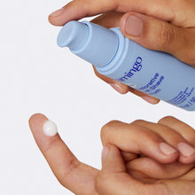 Person dispensing the Restorative Post Shave Serum onto their finger tip.