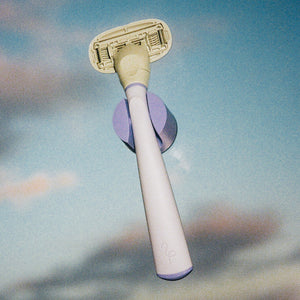Lilac Original Razor in its holder set an evening sky background.