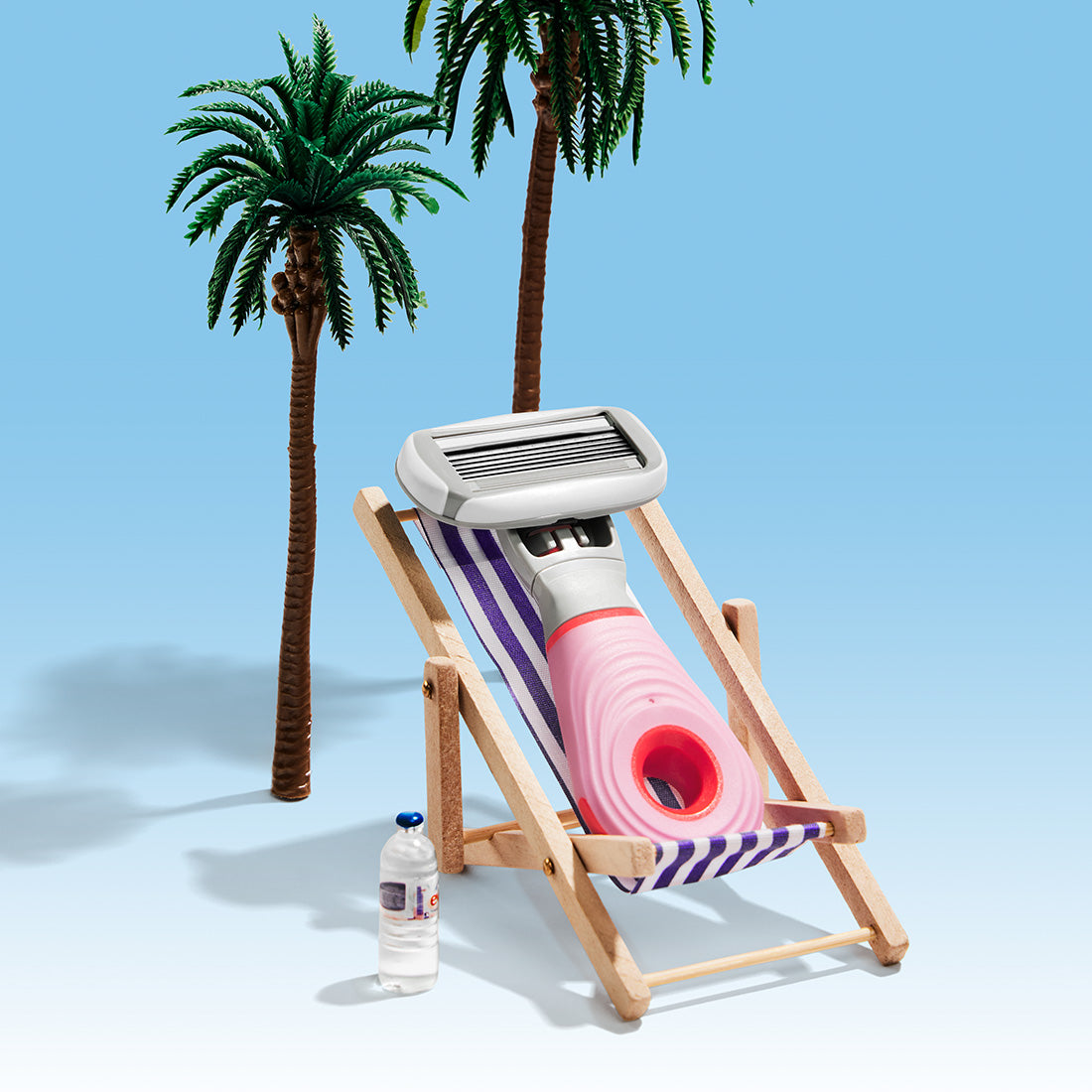 Mini razor sitting in a beach chair with palm trees and bright blue background.