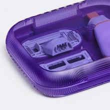 Close up of the see through purple plastic travel case holding an Original blade, Pubic blade and the mini travel handle.