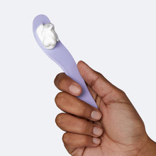 Woman holding the lilac spatula applicator for the Flamingo Body Hair Removal Cream