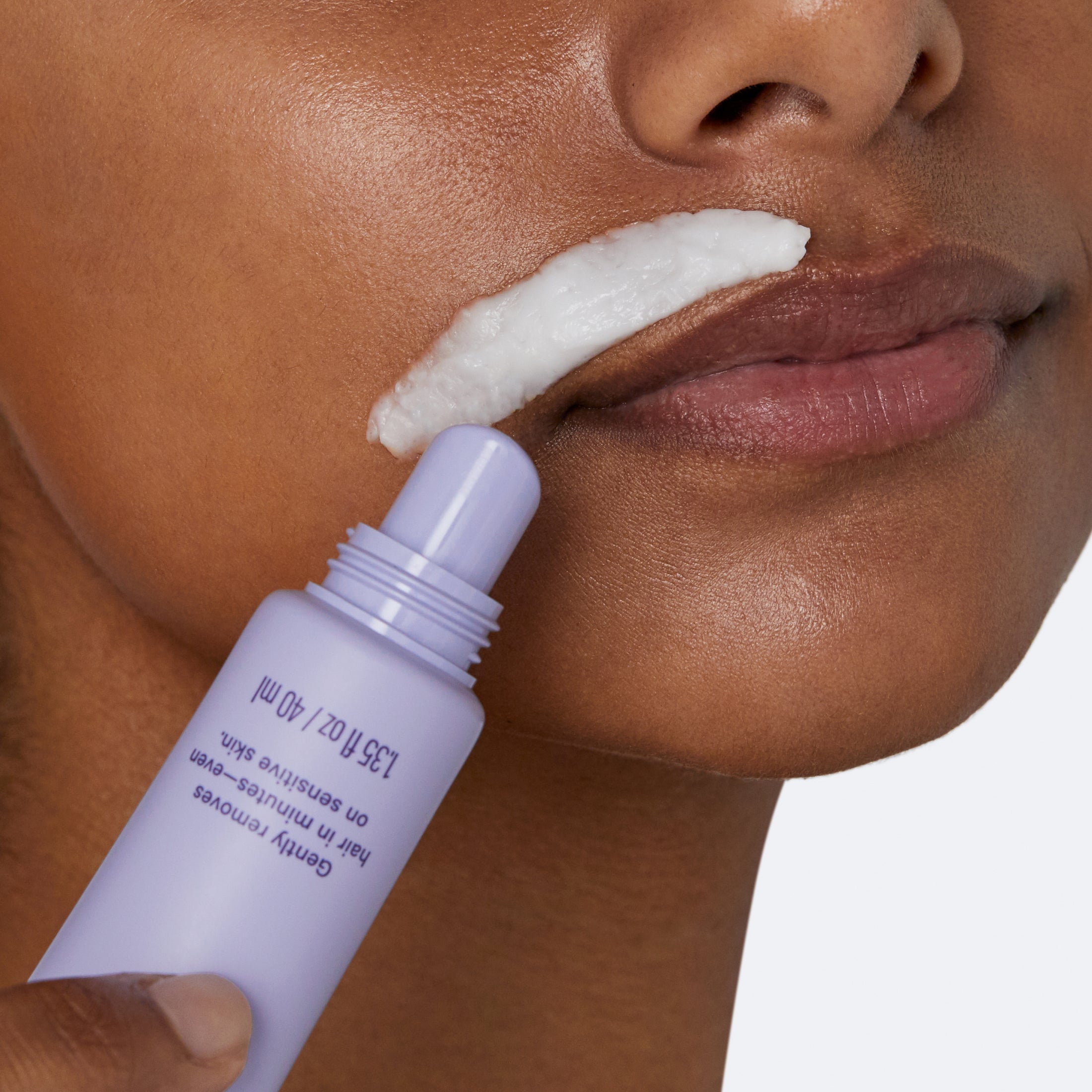 Woman applying Flamingo Facial Hair Removal Cream with the precision tip to her upper lip