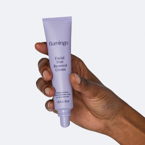 Woman's hand holding the small lilac tube of Flamingo Facial Hair Removal Cream