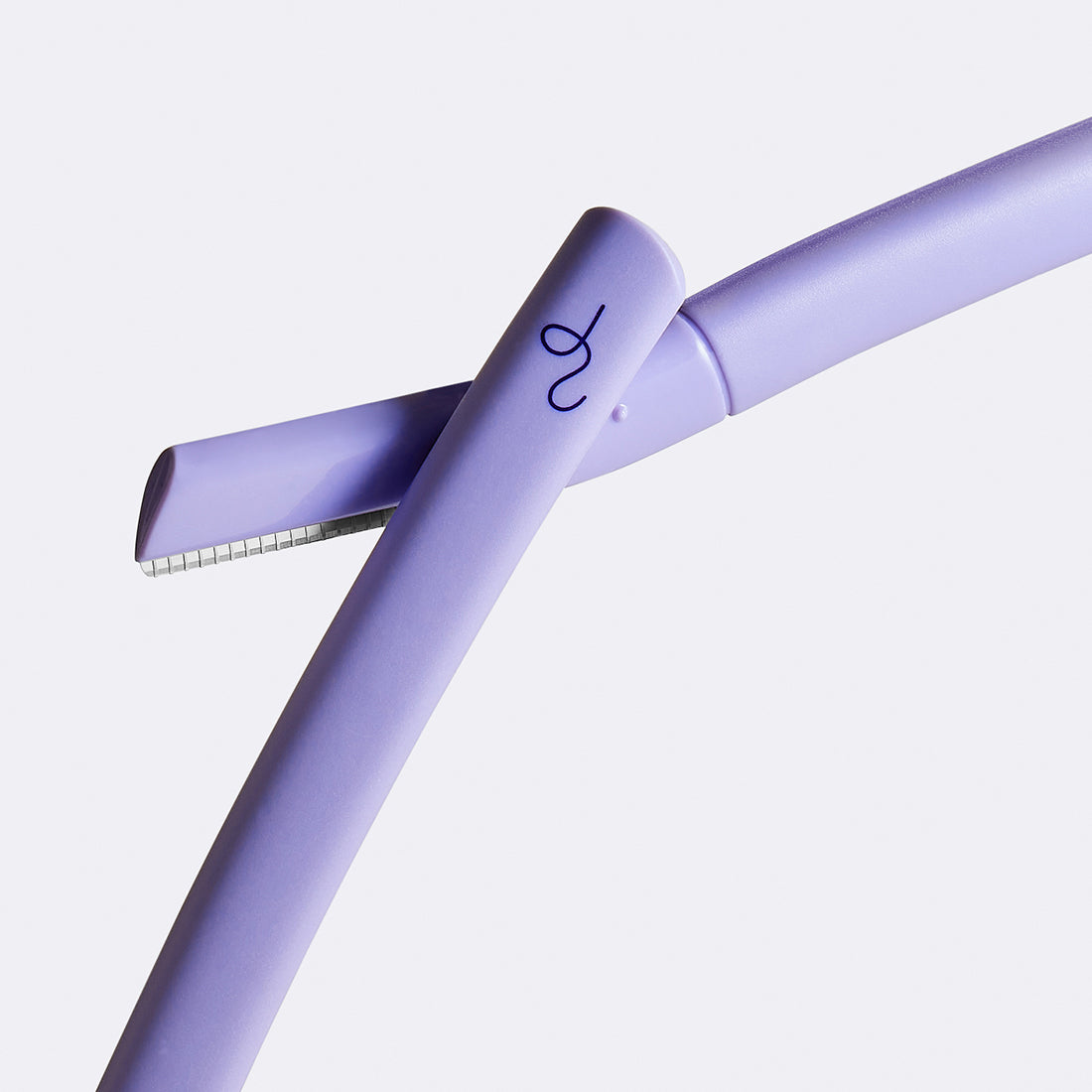Two lilac Flamingo Disposable Dermaplane Razors crossing over each other with the dark purple bird mark logo visible on one