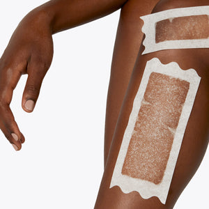 Womans leg pictured from the knee to above the ankle with two Flamingo Wax strips applied