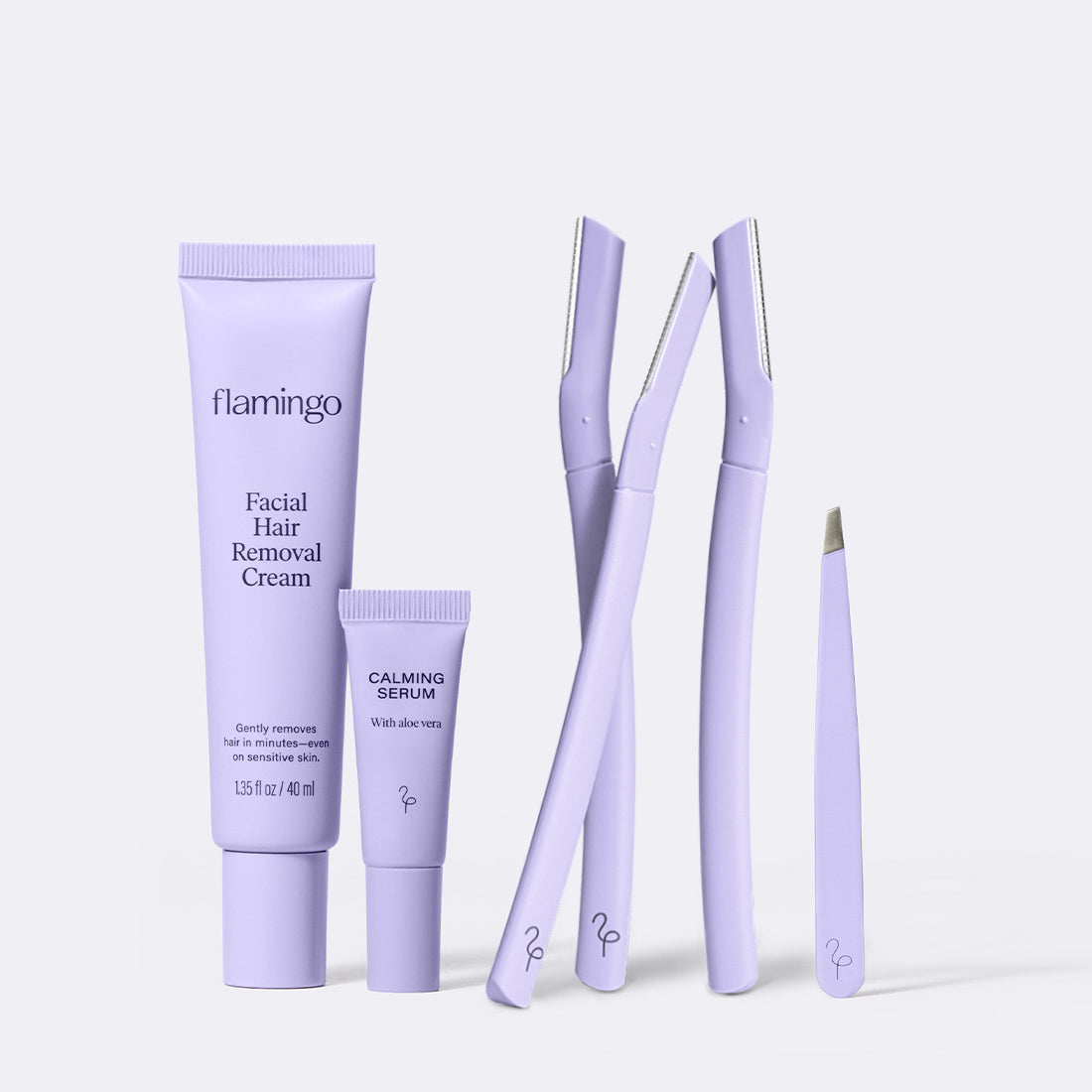 Flamingo Full Face Trio featuring Facial Hair Removal Cream, calming serum, three Disposable Dermaplane Razors, and lilac colored tweezers all displayed side by side