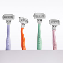 Lilac, Papaya, Sage, and Rose Flamingo Razors upright and side by side on a white background
